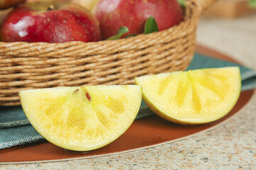 Fresh Apple Slices and Red Apples in Wicker Basket on Kitchen Counter