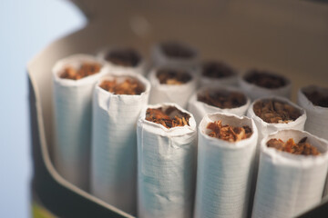 Cigarettes arranged in a pack showing fine tobacco inside