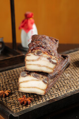 Woodfired Smoked Bacon Slices on Rustic Farmhouse Tray with Spices and Milk Bottle