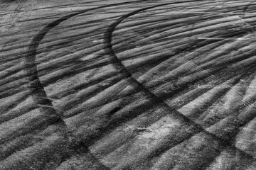 Black tire marks on road, Black rubber tire marks and tread marks, Tire trace track wheels texture and background, Auto tire tread grunge, Car wheel tyre tread track black tyre print.
