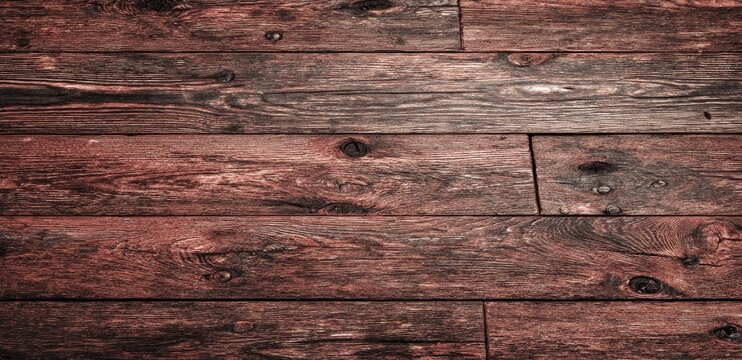 Close-up view of weathered, horizontal wooden planks, rich deep brown tones