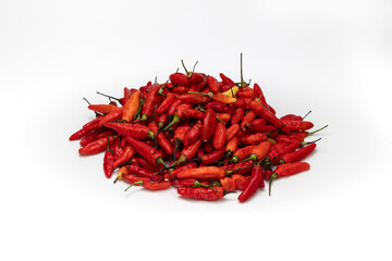 Fototapeta premium a pile of red birds eye chili pepper with shadow isolated in white background