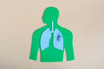 The silhouette of a man with diseased lungs, thickly sprinkled with ashes. The concept of the harm of smoking and smoking-related diseases