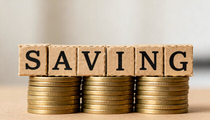 Cardboard cubes displaying SAVING on money stacks, perfect for business themes