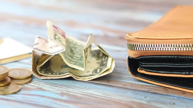 Saving money with a wallet on a wooden table