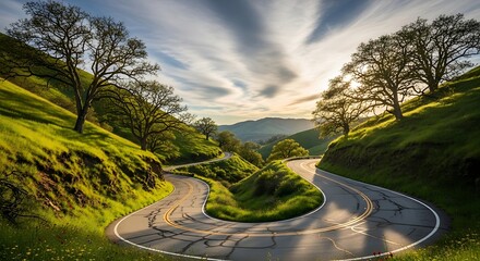 Winding Road Through Lush Green Hills at Sunset.