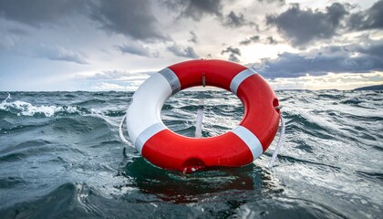Lifebuoy floating in stormy sea near misty mountains
