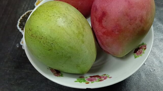 ripe green and red Appl  mangoes close up in a bowl. tropical fruits
