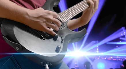 Naklejka premium Bassist's music man hands playing on guitar