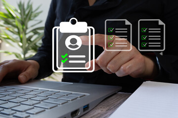 Correct personnel selection: person in front of a computer pointing and clicking on the resume of the right person