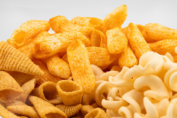 Assorted Crispy Snacks Mix in White Bowl on White Background