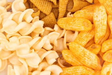 Assorted Crispy Snacks Mix in White Bowl on White Background