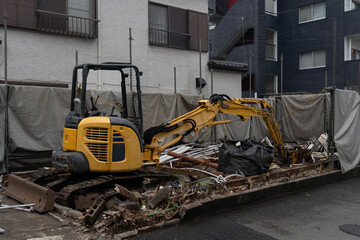 Excavator clearing debris after house demolition © Daria
