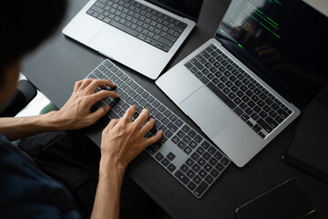 Asian man software engineer Working on Computer at office desk for writing program code IT Software Engineer finding errors tech support devops creating digital