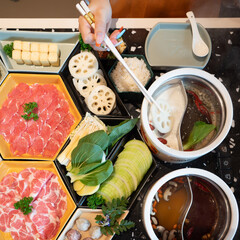 young girl  eating original mala spicy hot pot in restaurants