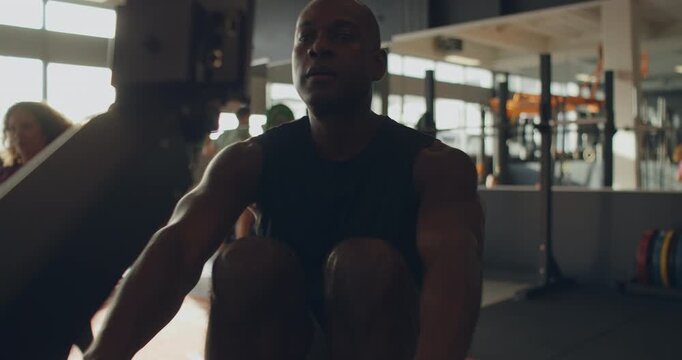 Fit young black man in sportswear
exercising on a rowing machine
during a gym workout session