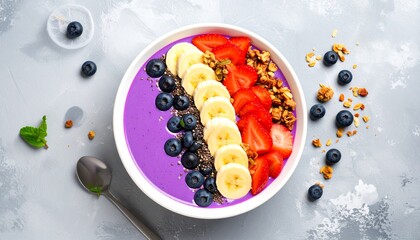 Healthy smoothie bowl with fresh berries banana and granola.