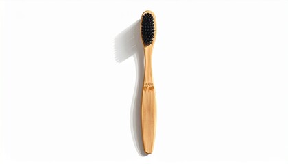 Natural bamboo toothbrush with black charcoal bristles isolated on white background.