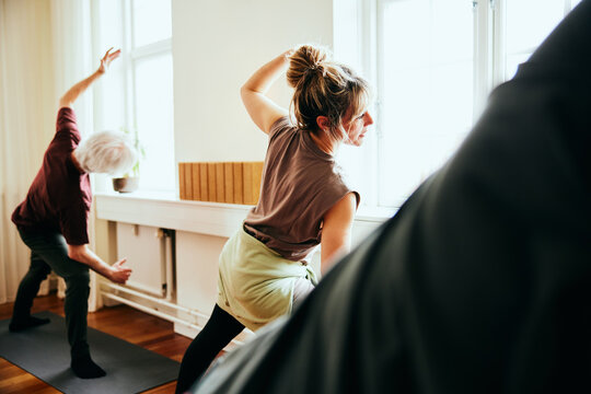 Yoga teacher leading a class in a studio