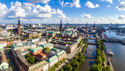Obraz premium Panoramic cityscape view of Hamburg, Germany, showcasing the city's architecture, waterways, and lush greenery, with a bright sunny day.