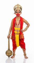 Obraz premium happy indian little boy wearing lord hanuman costume standing on white background