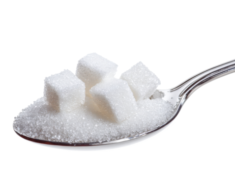 A spoonful of sugar cubes isolated on a white background