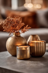 Elegant golden candles and decor create a warm, inviting ambiance in a cozy setting.