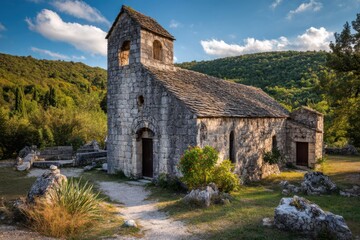 Rustic Stone Church Surrounded by Lush Green Landscape in Nature