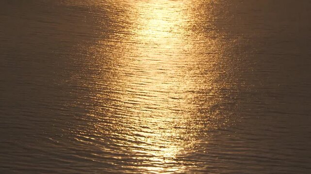 HD ground-level footage of a spectacular sunset over the Pacific Ocean, filmed from the rugged Big Sur coastline in California. The clip captures the dramatic colors of the sky, the sun dipping into t