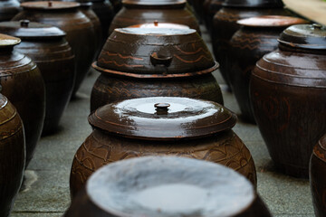 wet traditional Korean food container made of ceramic called onggi in the rain