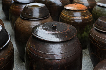 wet traditional Korean food container made of ceramic called onggi in the rain