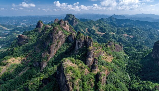 Rugged mountain peaks, covered in greenery, rise amidst a vast landscape