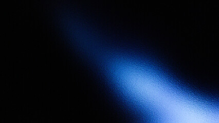 Abstract blue light beam shining through darkness creating a textured gradient