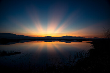 Sunburst rays of sunshine at sunrise near Lake Perris