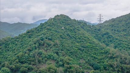 July 12 2025 Lush Green Forested Hills with Powerlines and Mountainous Terrain