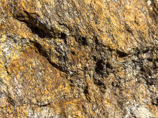 Close-up of rough natural rock surface with brown and tan textures