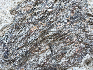 Rugged rock texture with layered striations in natural formation