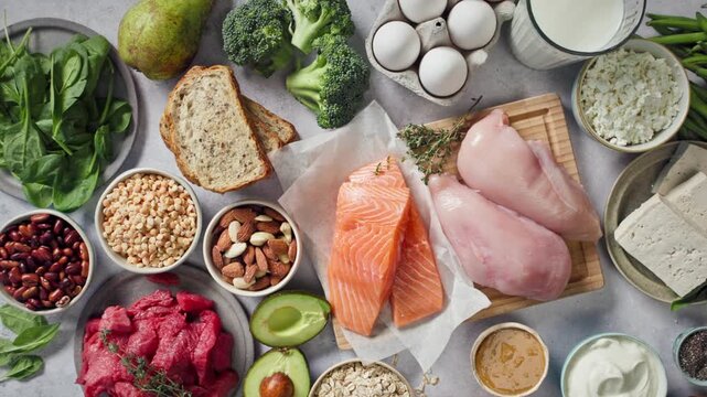 flat lay composition of various fresh protein diet products on grey background, top view. healthy eating, various fresh healthy products on grey table, top view. Healthy food clean eating selection