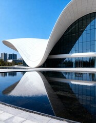 Futuristic cultural building with curved white roof and water reflection 

