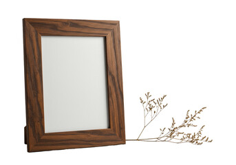 Empty rectangular dark brown rustic wood frame with textured grain beside a delicate dried botanical sprig, isolated on a transparent background with bright studio light. Minimalist product