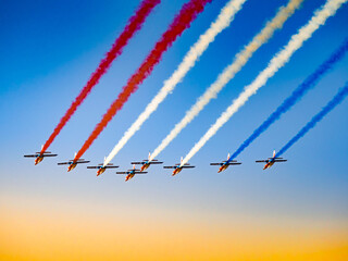 Patrouille de France flying in formation on a clear blue sky at an airshow