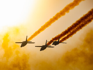 Airshow performance in the warm light of the sunset made by skillful pilots on the skies of...