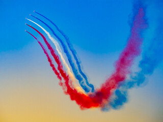 Patrouille de France flying in formation on a clear blue sky at an airshow