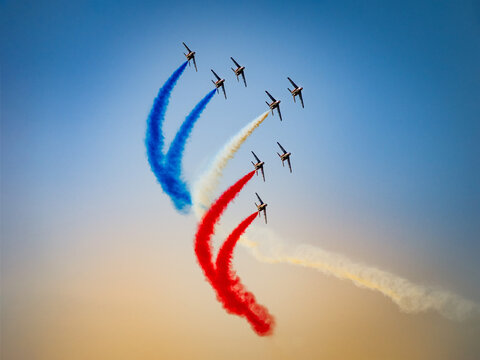 Patrouille de France flying in formation on a clear blue sky at an airshow - Powered by Adobe