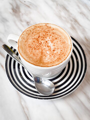 Marble Morning: Cappuccino Elegance with Striped Saucer and Spoon