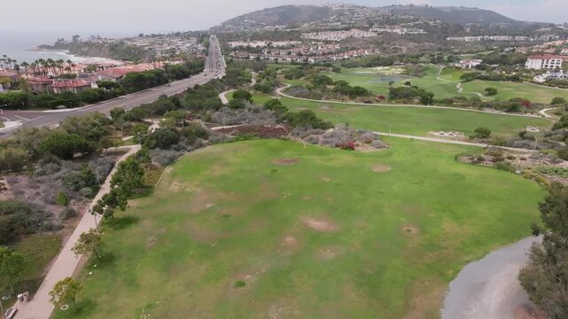 Drone footage flying next to Pacific Coast Highway and golf course