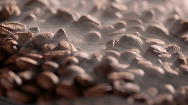 coffee beans background. Black coffee beans with steam