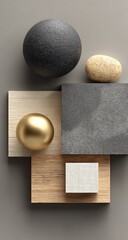 Abstract still life of smooth stones, metallic sphere, and geometric wooden blocks on a neutral background