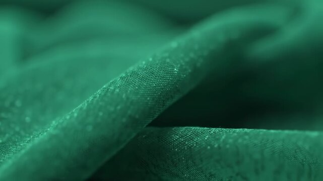 Close-up of emerald green fabric with a textured surface