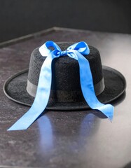 Black hat with blue ribbon